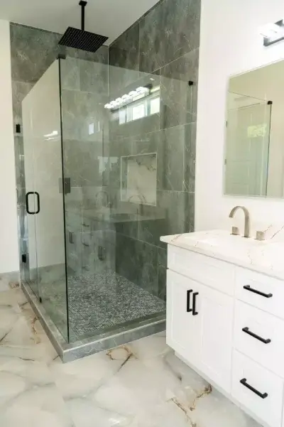 Stunning bathroom with large format polish stone gray tiles that are easy to clean and perfect for a modern look